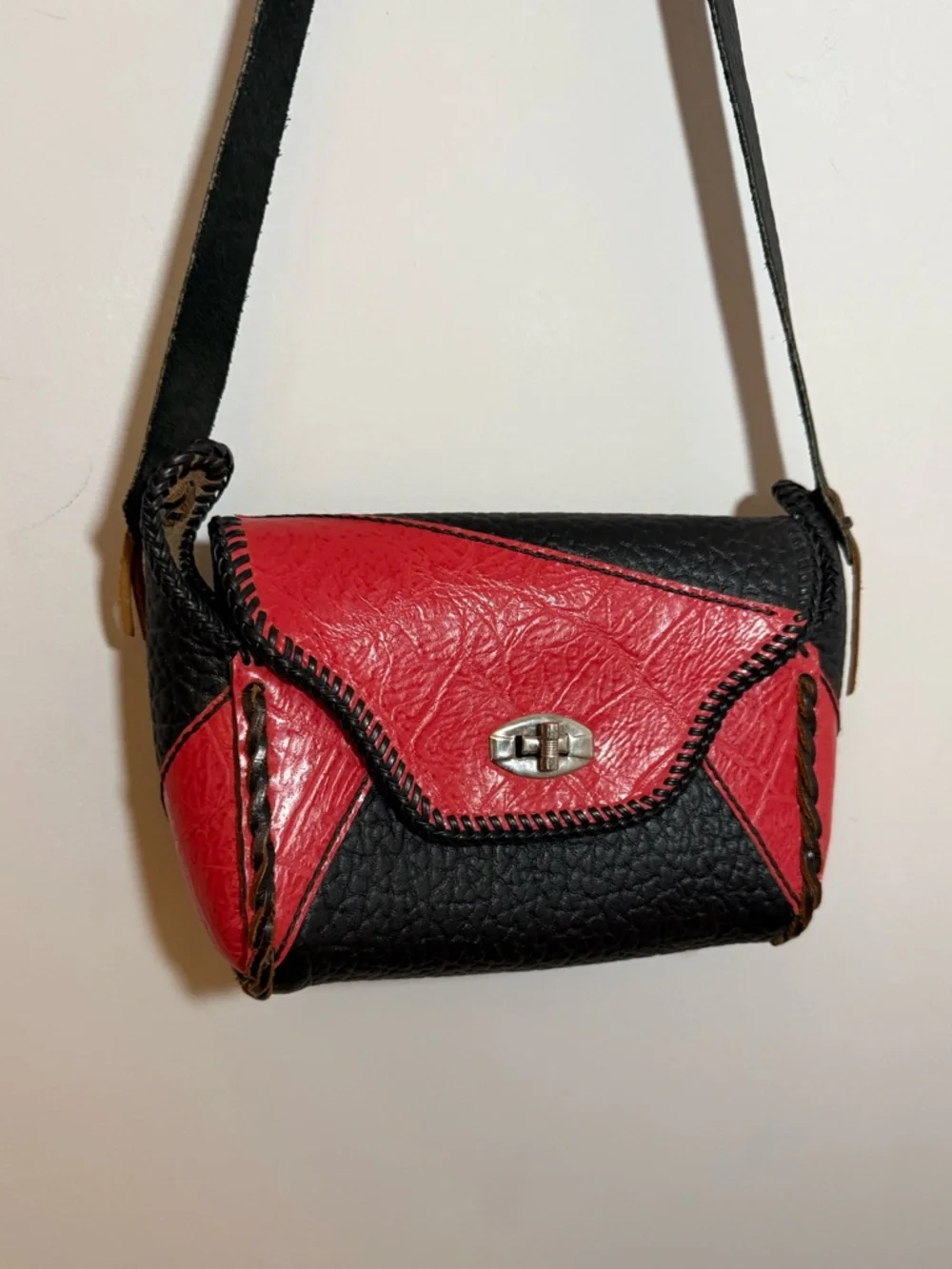 Vintage western leather black and red braided sides fringe shoulder bag purse.